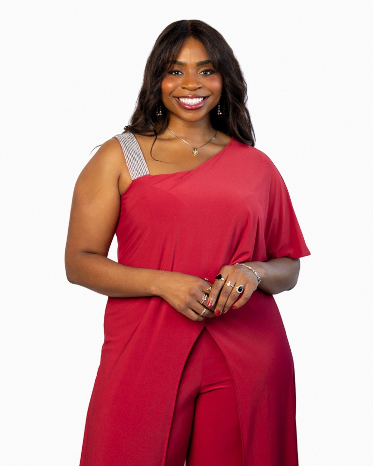 Lira Ndifon standing and smiling in a red outfit